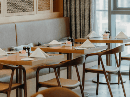 Dining tables arranged in CineScope Restaurant at Paramount Hotel Midtown