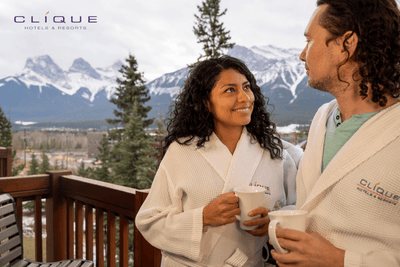 Well-lit dining area at Falcon Crest Lodge features a large window with scenic mountain views and a table set for four