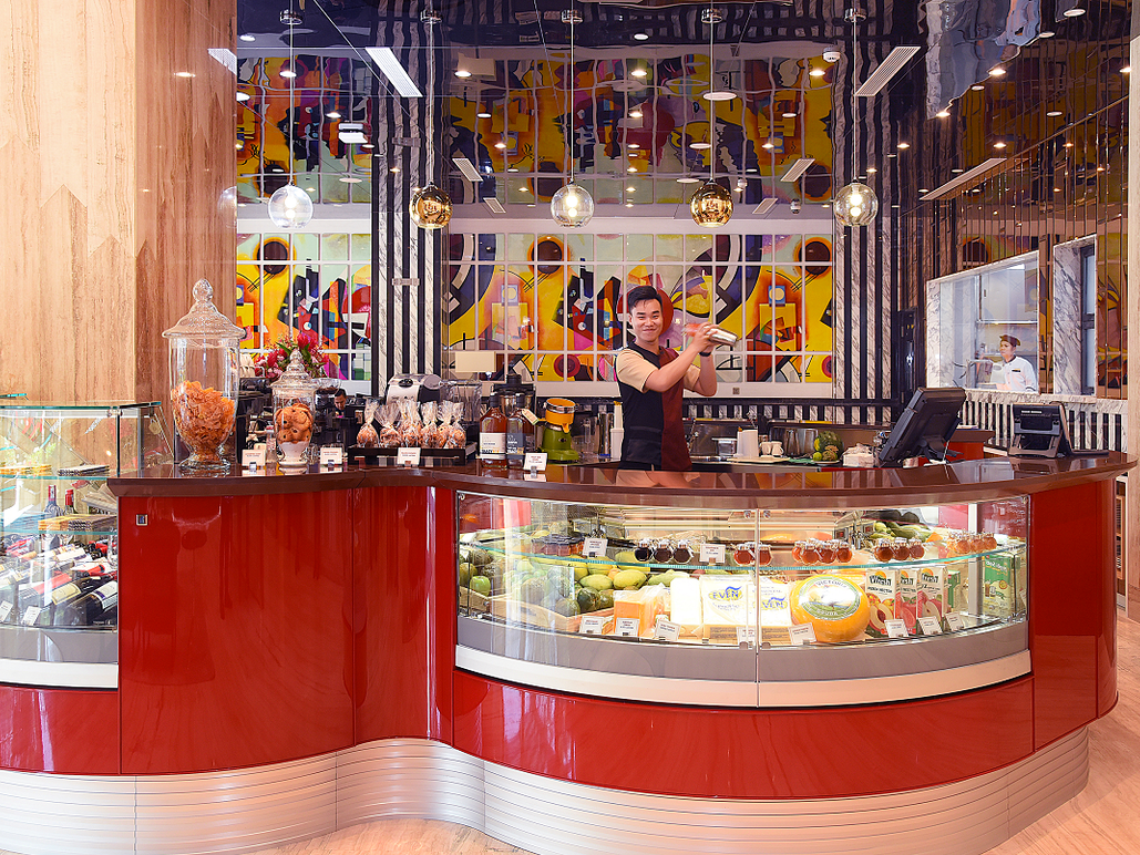 red display counter with barista shaking drinks