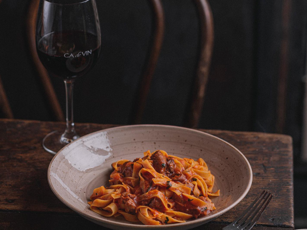 Bowl of pasta & glass of wine served at Brady Central Melbourne