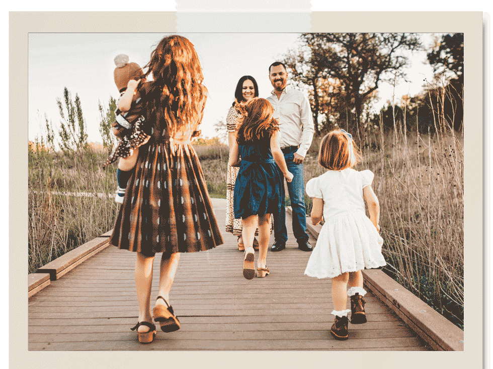 Family at Sunset on Dock with Kids running towards aunt and uncle