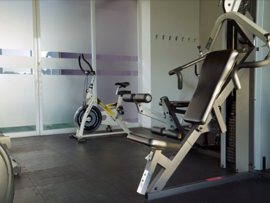 Interior of the gym with fitness machines at Gamma Hotels