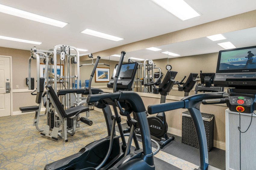 a fitness room with exercise equipment