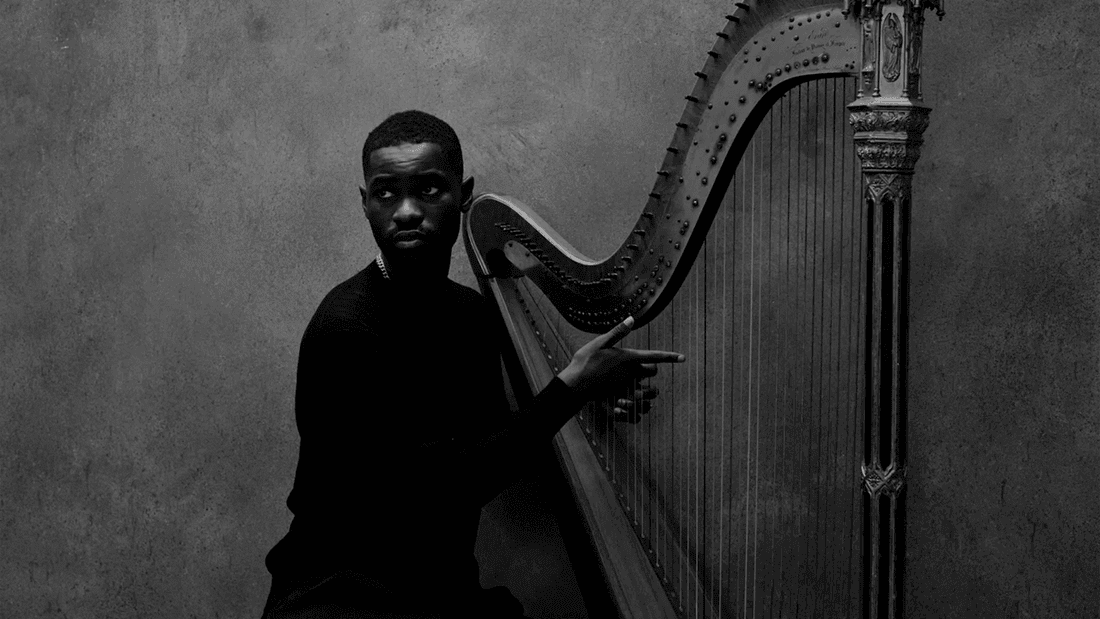 Man pointing to harp in black and white image for Dave - The Boy Who Played the Harp 2026 event.