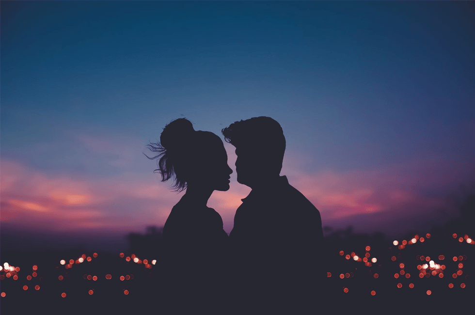 Romantic couple against a sunset background