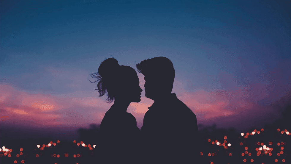 Silhouette of couple overlooking the city at sunset near Sunway Hotel Hanoi