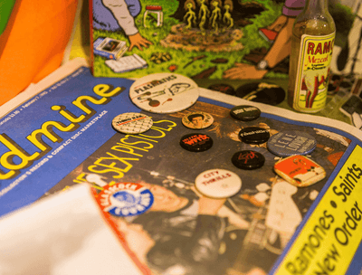 A table with a bunch of buttons on the magazine at The Verb Hotel