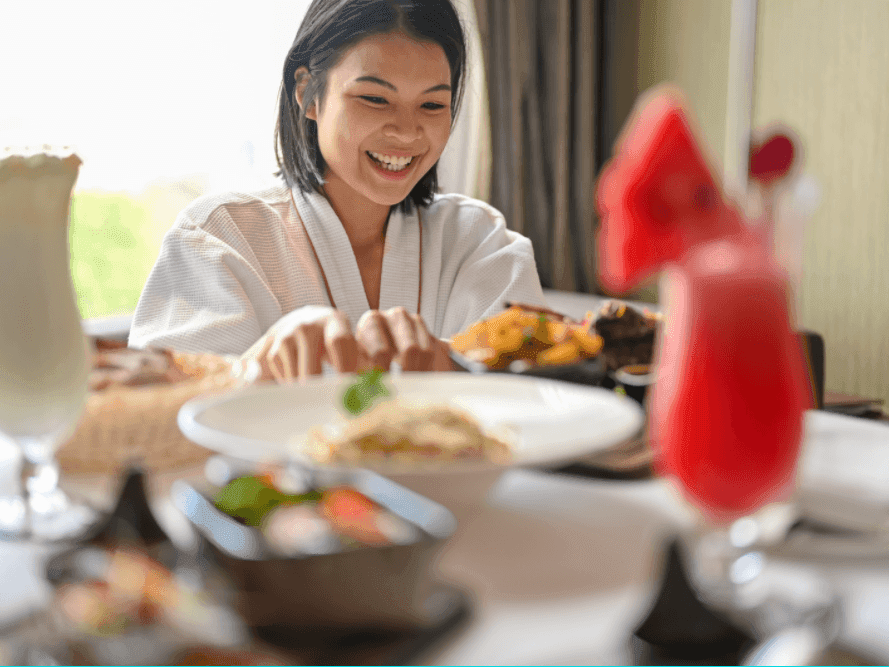 A girl dining in a room at Two Seasons Hotel & Apt