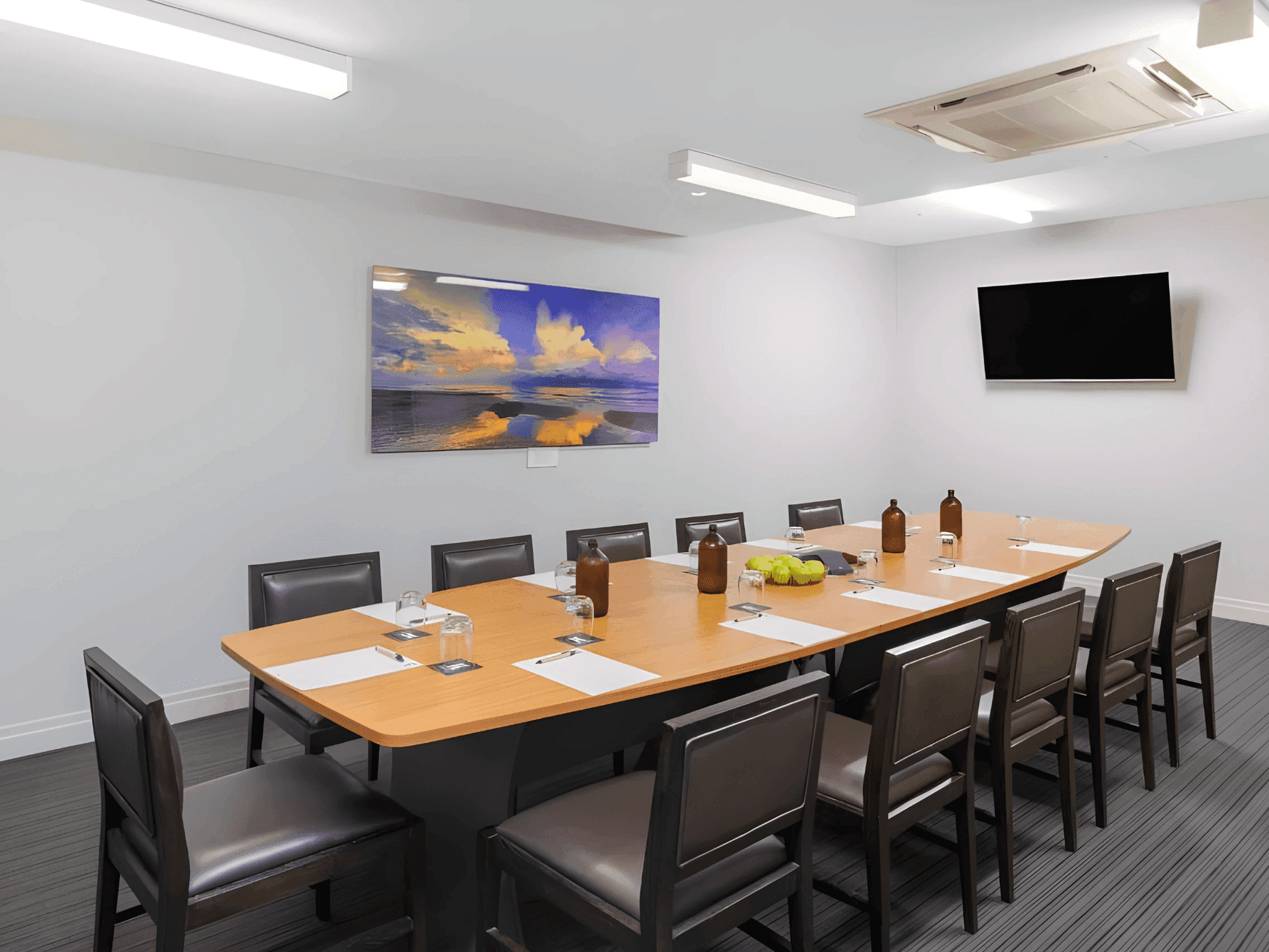 Spacious meeting room with boardroom table layout and TV at The Smith Hotel Darwin