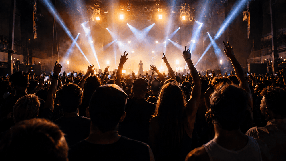 Energetic crowd with raised hands at a concert venue