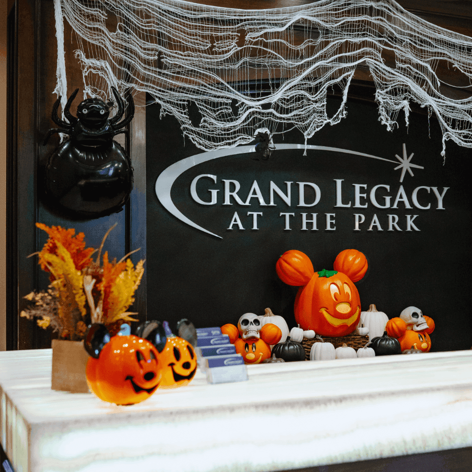 Halloween decorations with pumpkin-shaped Mickey Mouse and festive accents displayed at Grand Legacy At The Park reception desk