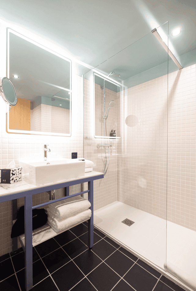 Bathroom shower & vanity in Studio Room at Kopster Hotel Paris Ouest Colombes