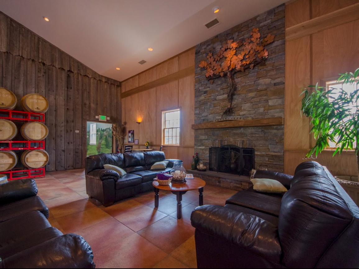 wood and brick lined room with fireplace and sofa