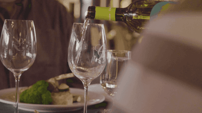 Closeup of pouring wine to glass at Hotel Mont Gabriel Resort
