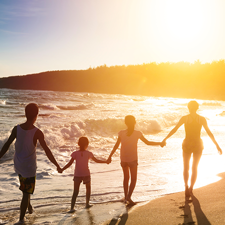 Family walking on the beach with Sunrise view of beach - Lexis Hibiscus