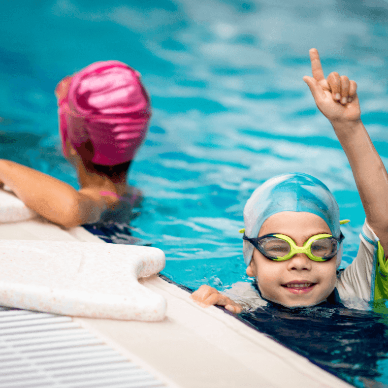 Swimming classes in Dubai with a kid swimmer in pool