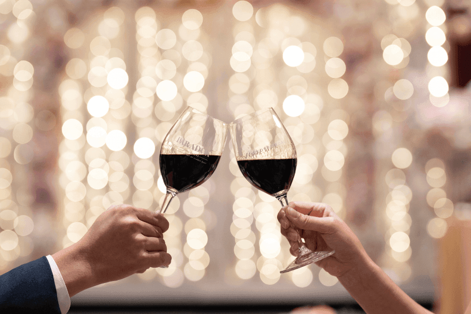 A couple toasting with wine glasses at Paradox Singapore