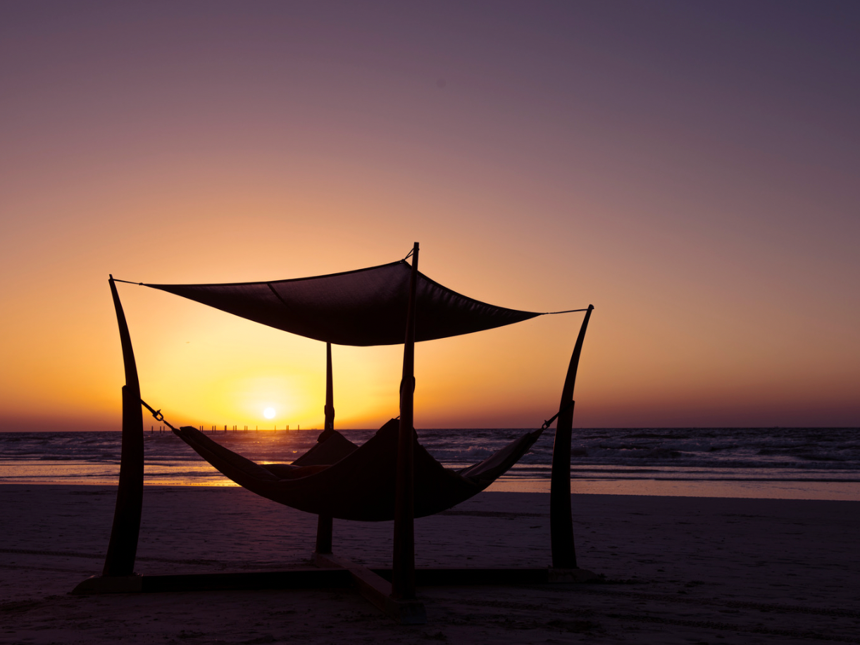 A relaxing area on the beach with sunset at Ajman Hotel