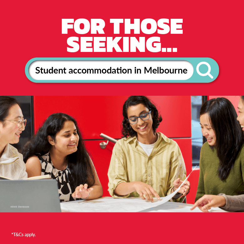 Four smiling students working together with a laptop at Student Living D2.