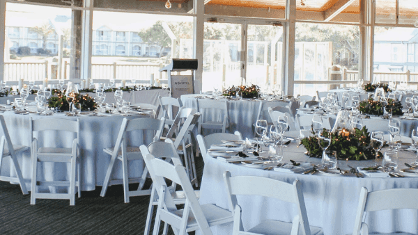 Elegant dining setup with banquets by a large window in Lily’s on the Lagoon at Novotel Sunshine Coast Resort