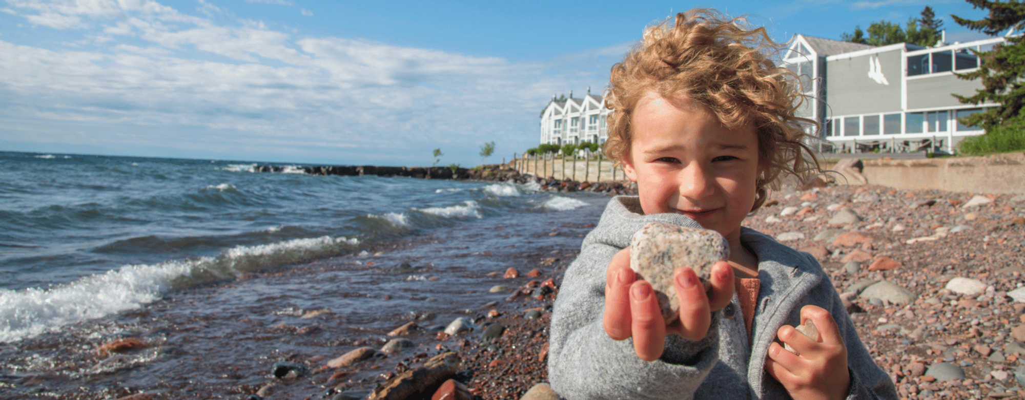 Small child by the sea near Bluefin Bay Family of Resorts