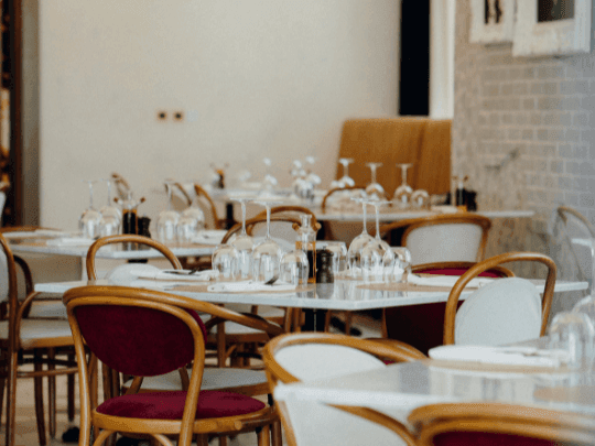 Dining tables arranged in Paparazzi Tuscan Restaurant at Paramount Hotel Midtown