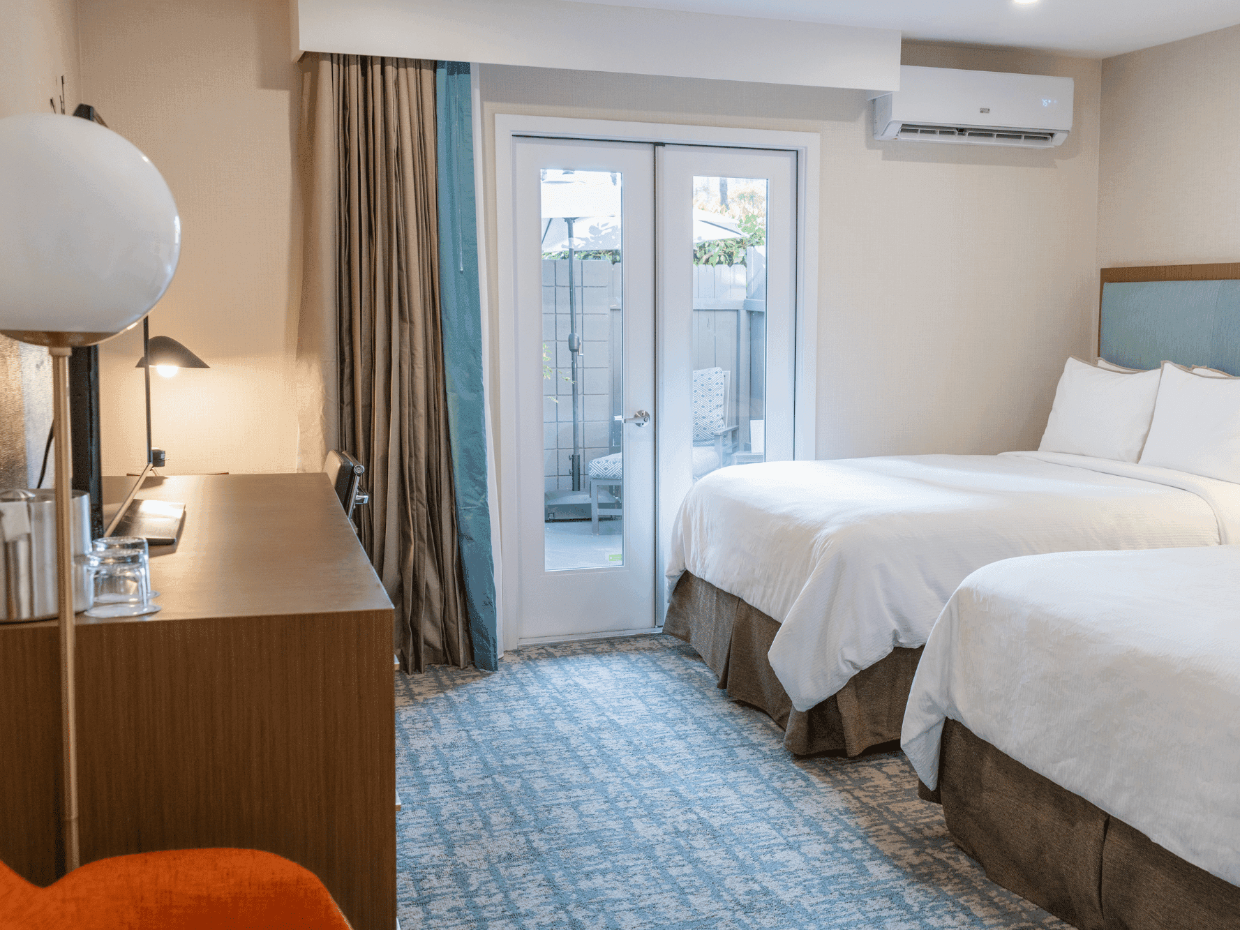 Premier Queen bedroom with french doors, A/C unit, TV and TV stand