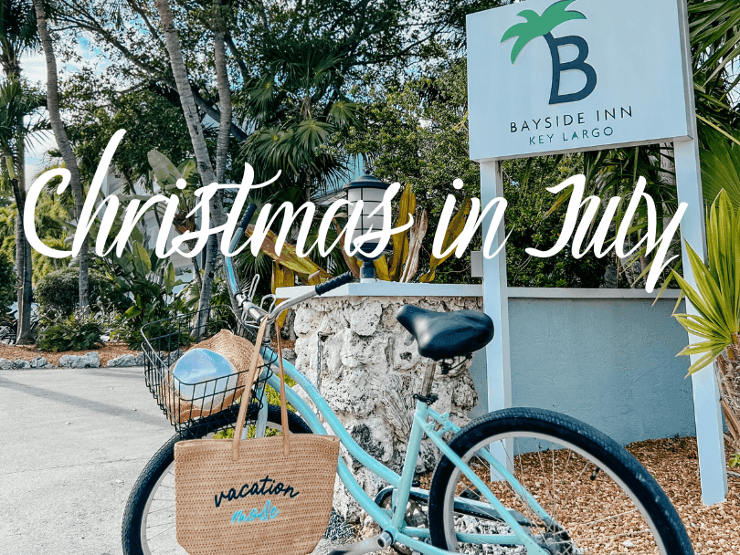 Blue bicycle with vacation tote bag near Bayside Inn Key Largo sign, with text