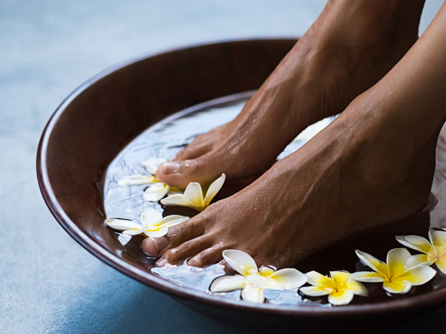 feet soaked in floral water for spa treatment at Amora Hotel