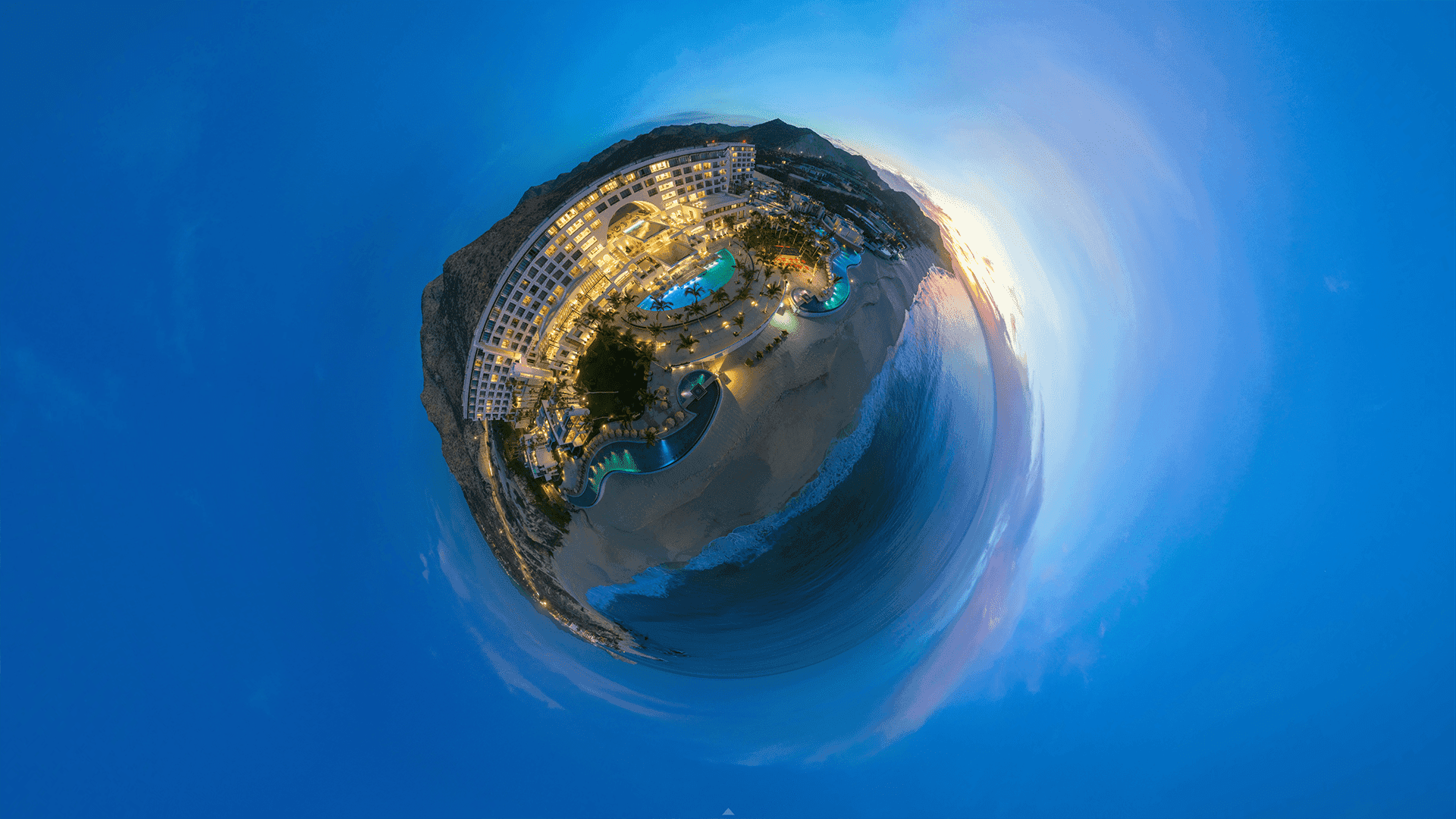 360-degree aerial view of beachfront Marquis Los Cabos, surrounded by ocean and mountains