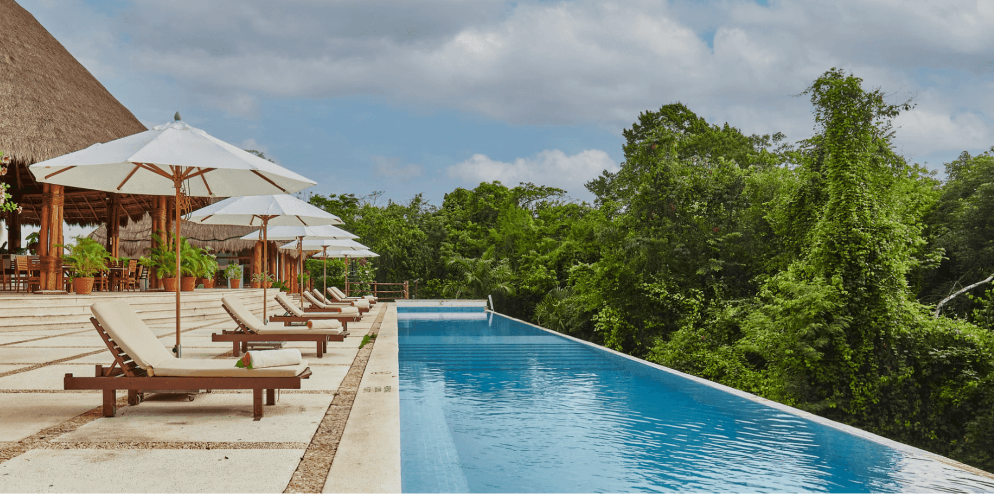 Outdoor pool with sun loungers at The Explorean Kohunlich