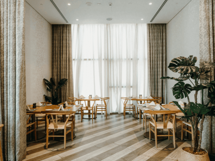 Dining tables arranged in CineScope Restaurant at Paramount Hotel Midtown