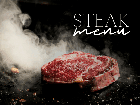Surowy stek wołowy z marmurkowaniem na ciemnym tle z unoszącą się parą i napisem Steak Menu