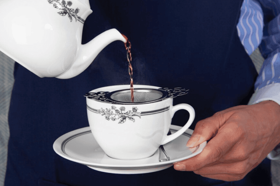 waiter pouring tea into Laura Ashley cup