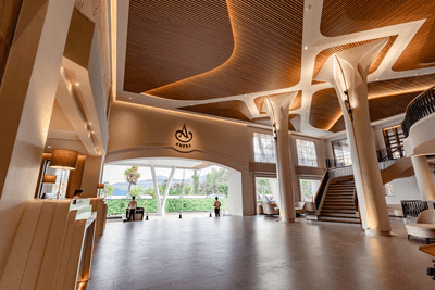 Interior view of the elegant entrance and lobby area with a wooden ceiling at Amora Hotel