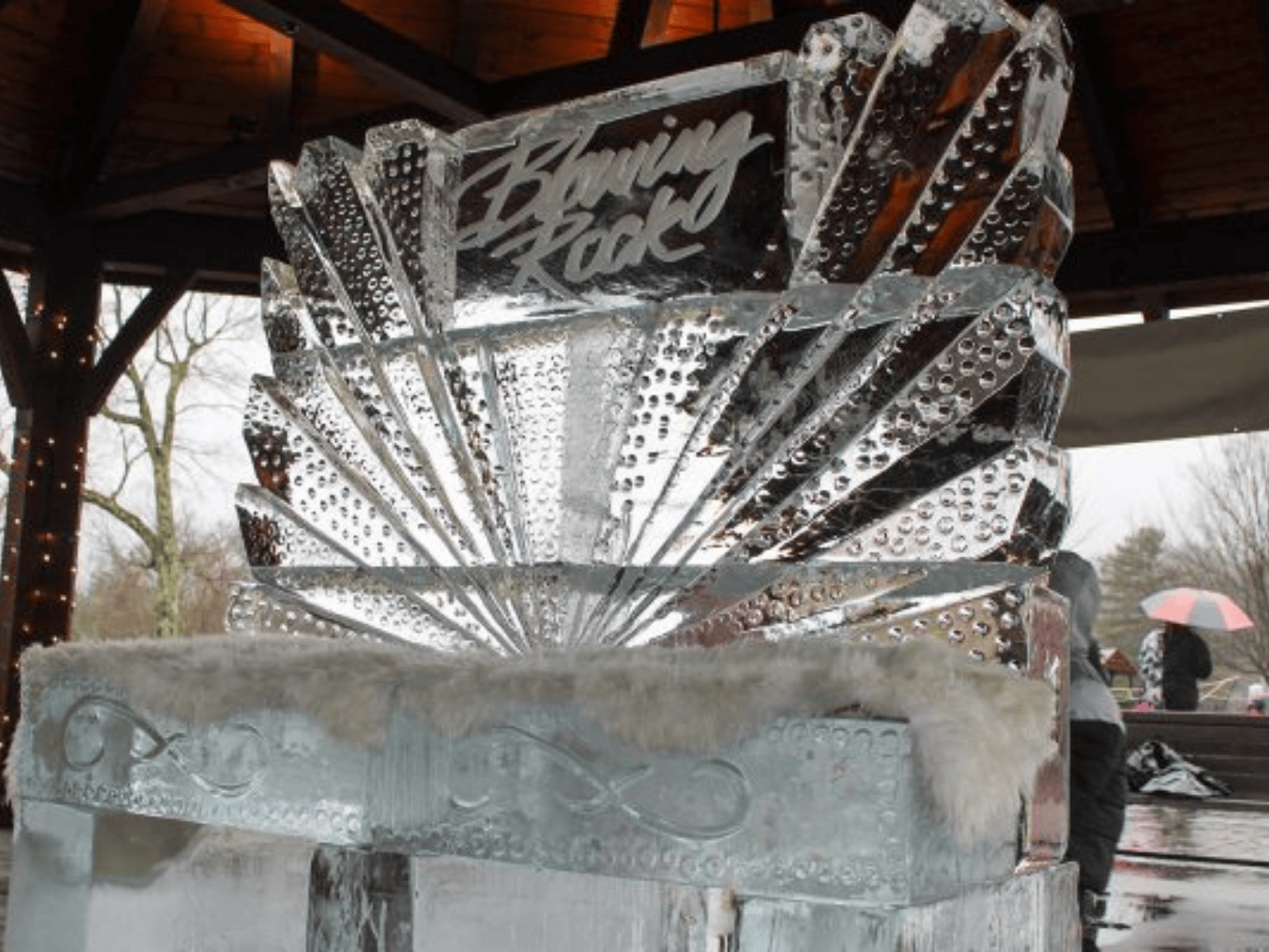 A handcrafted ice carving placed on a podium as the first place winner