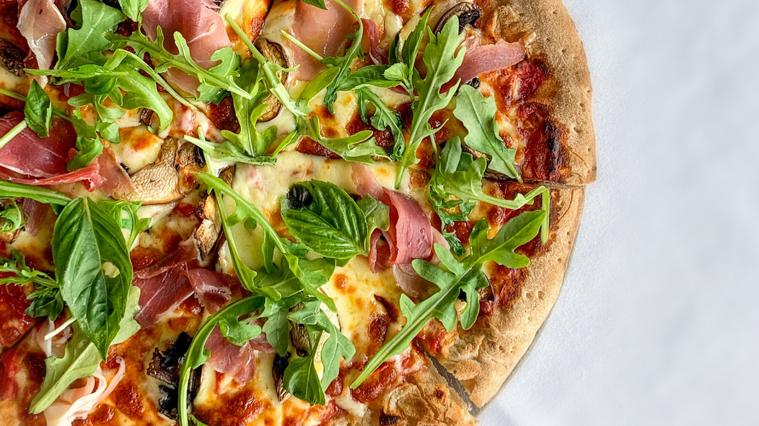 A delicious pizza topped with prosciutto and fresh arugula served in Sola Bar & Restaurant at Novotel Sunshine Coast Resort