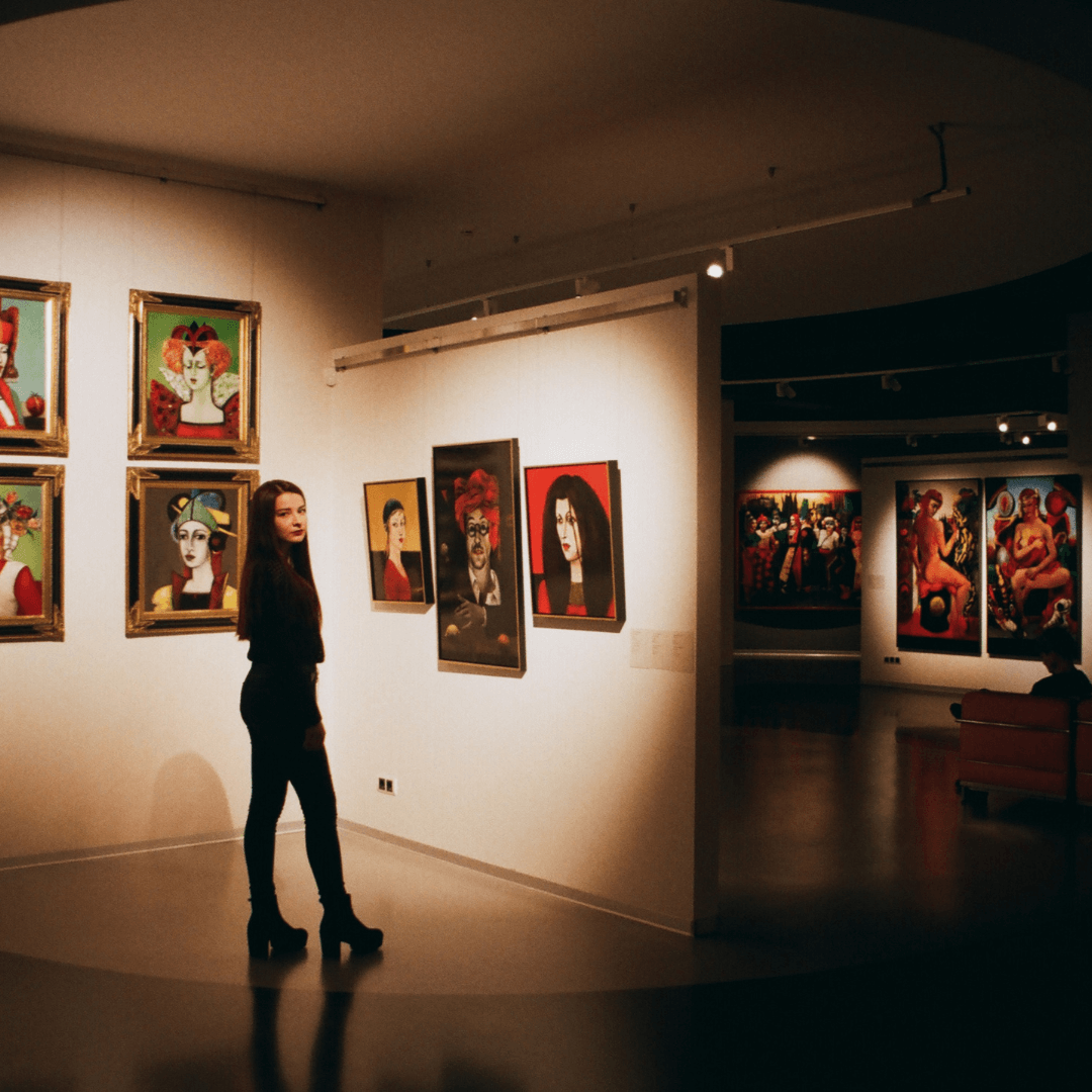 A woman wondering and admiring art at a holiday themed gallery.