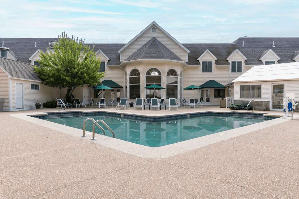 A pool area with a building in the background