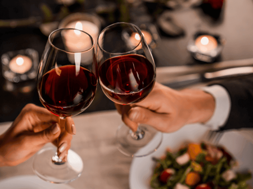 A couple toasting a glass of wine at The Breakwater Inn & Spa