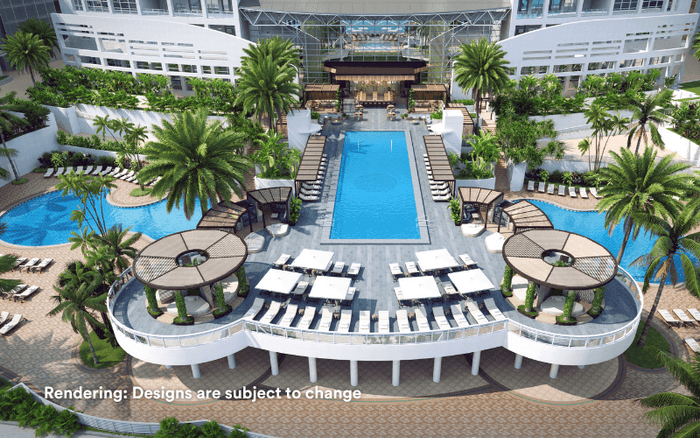 Aerial view of pool area with loungers and palm trees at Diplomat Beach Resort