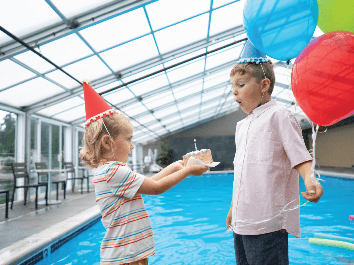 Kids enjoying birthday cake & balloons by the indoor pool area at Alderbrook Resort & Spa