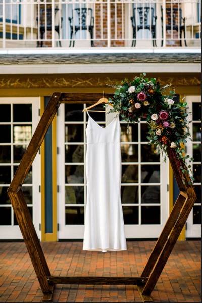 Wedding dress hanging on a wooden frame at Horton Grand Hotel