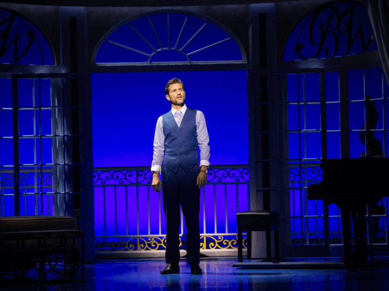 Ben Hall on stage performing Pretty Woman: The Musical Package.
