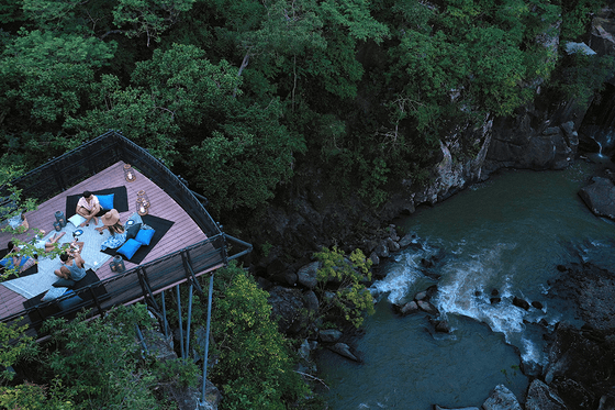 Friends having picnic on a spacious balcony by the River at Hotel Rio Perdido