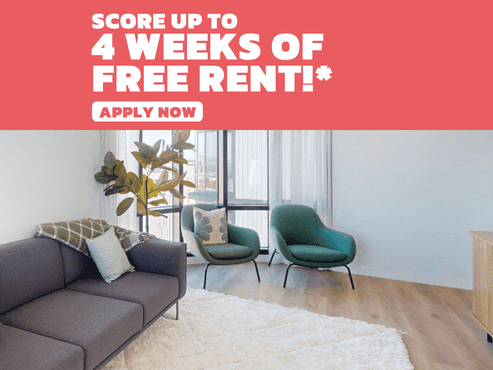 Modern living area with grey sofa, teal chairs, and balcony access at UniLodge Perth Central in Perth