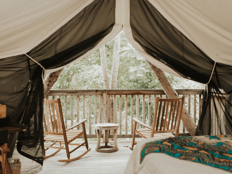 glamping tent with wooden rockers