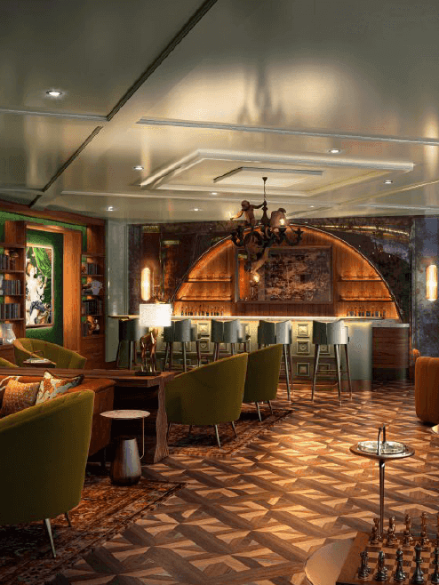 Cigar bar with green seating, a bar area, shelves of books, and stylish decor at El Conquistador Resort