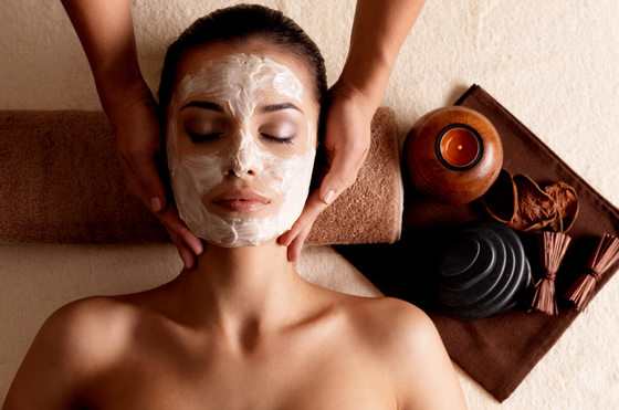 Lady with facial mask having a massage at Amora Hotel