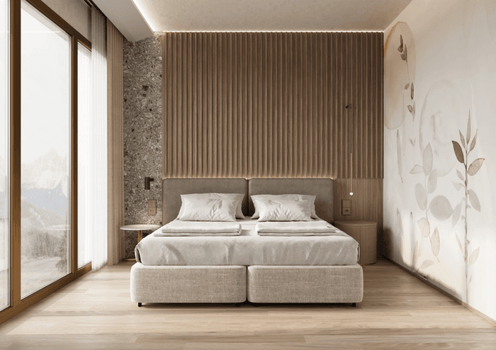Bed with a side table by the large window and wooden floors in Suite Junior - Family with balcony at Hotel des Innovations